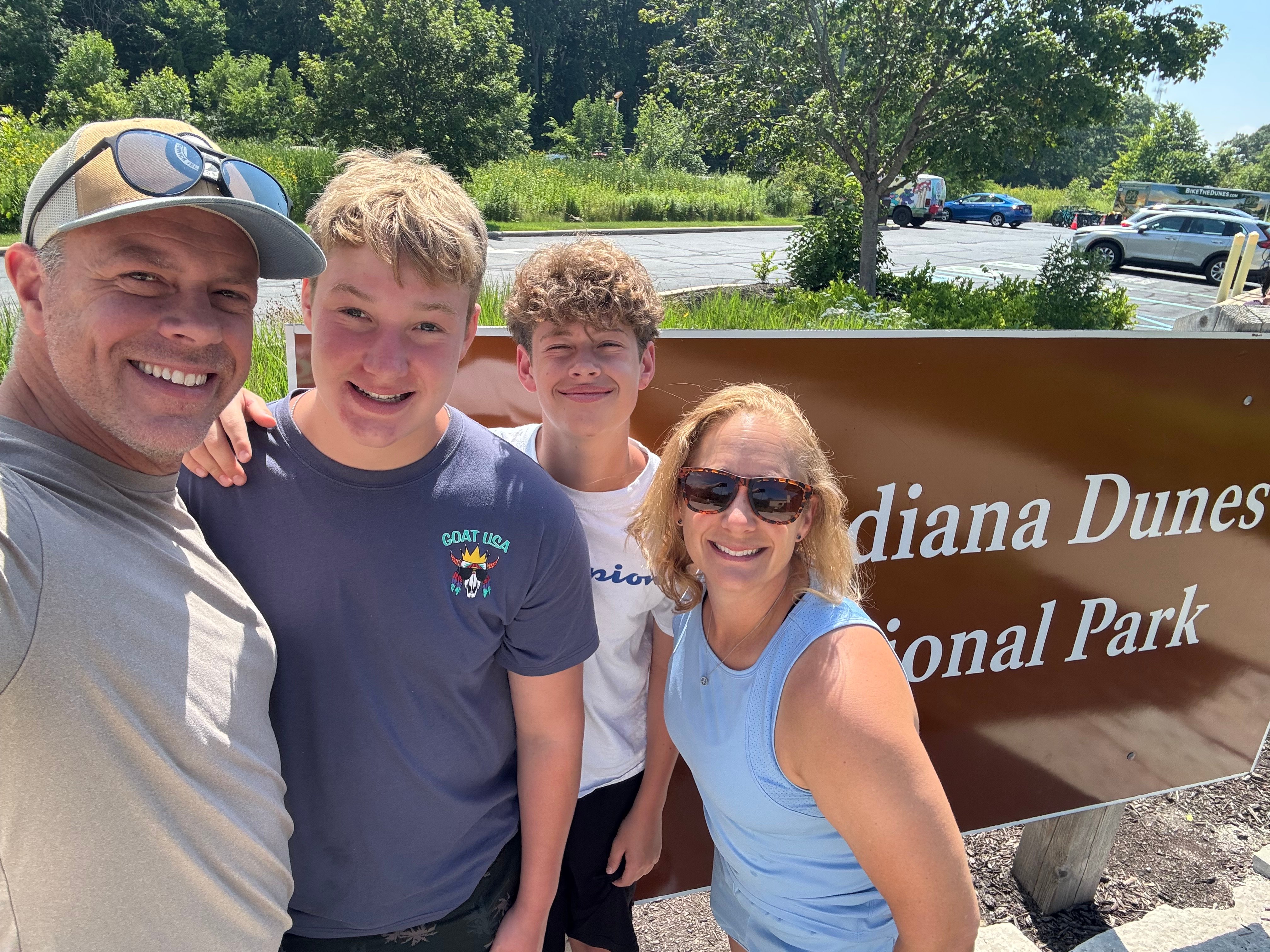 Resident Principal's family in front of the National Park Sign